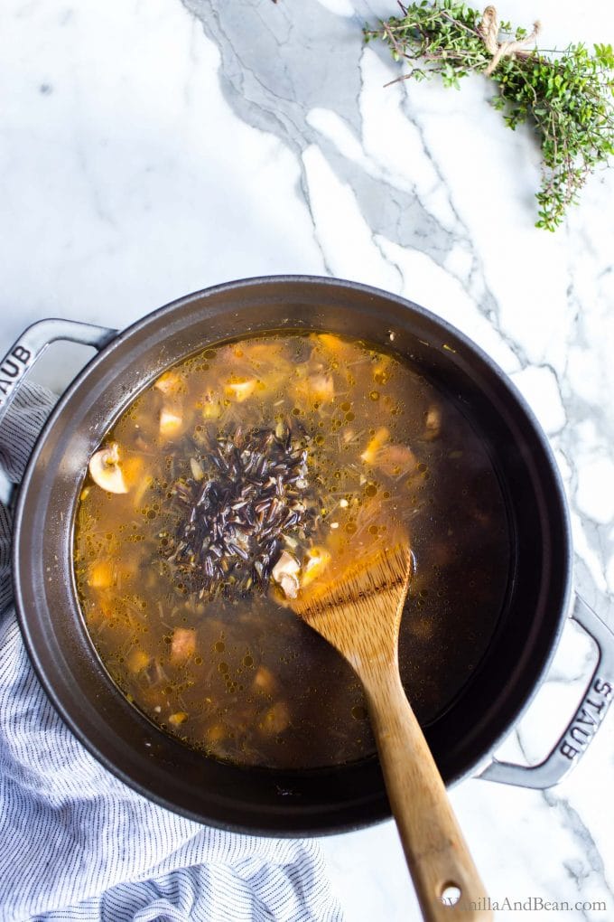 A Dutch oven with Mushroom Wild Rice Soup in it. 
