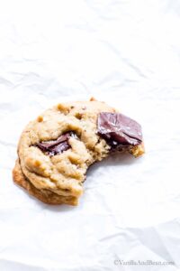 Close up of a Sourdough Discard Cookie with chocolate chips and a bite taken out of it.