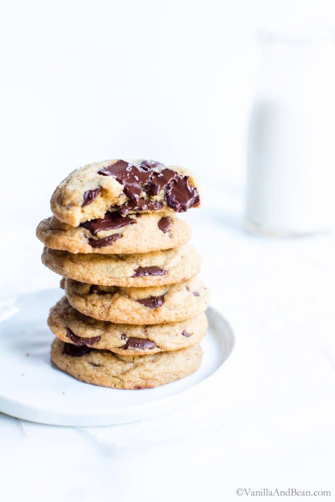 Sourdough Chocolate Chip Cookies stacked on a plate. 