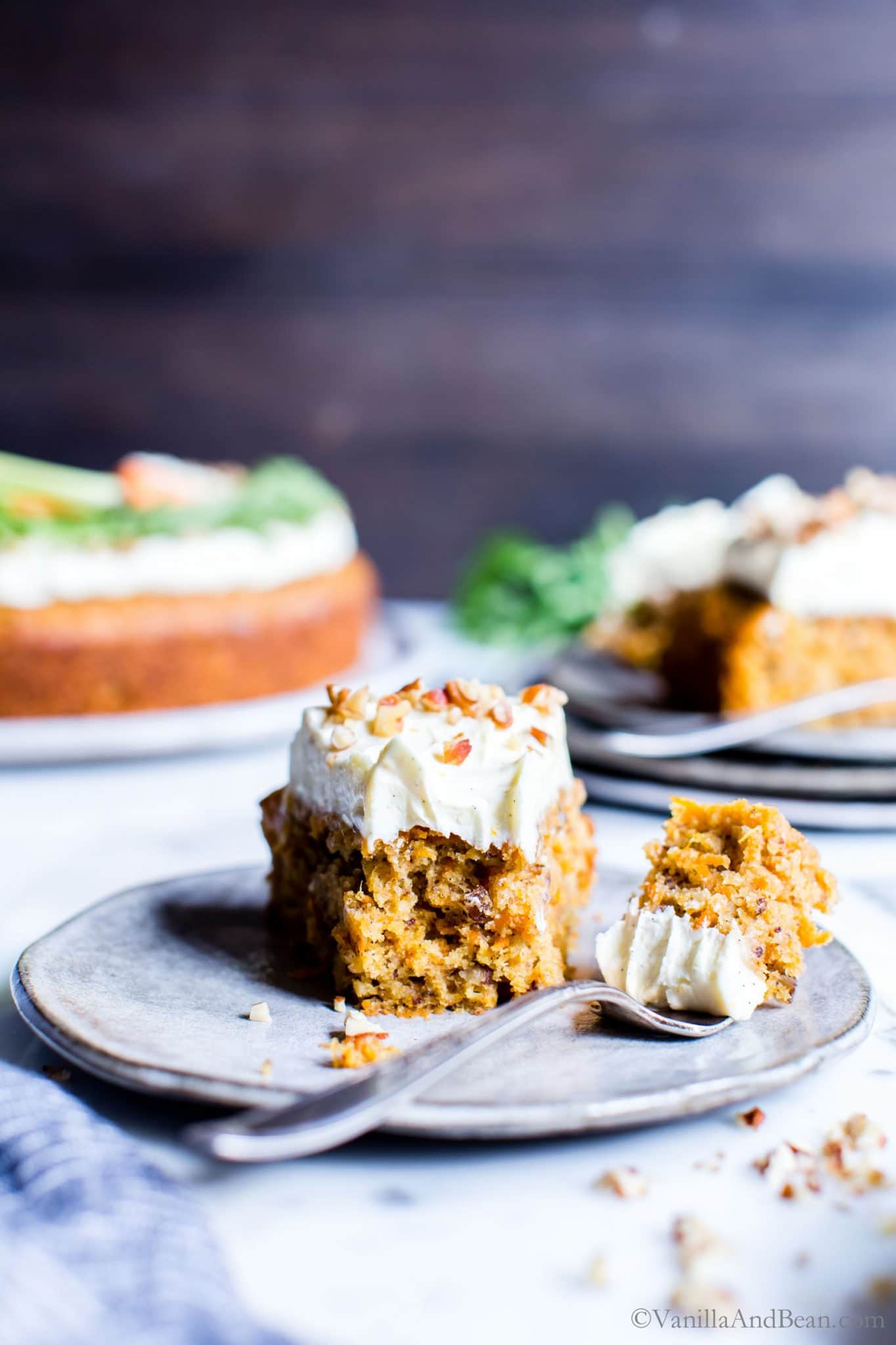 Easy Carrot Cake Recipe slice on a plate with a bit taken out of it.