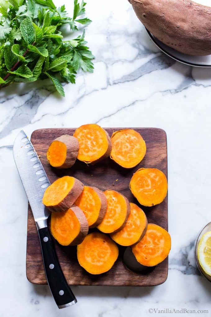 Sweet potato slices on a cutting board.
