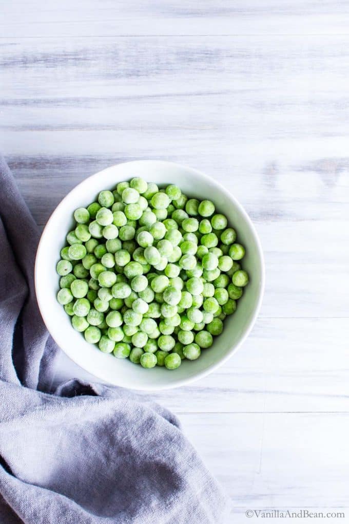Frozen Peas in a bowl for this vegan pasta salad.
