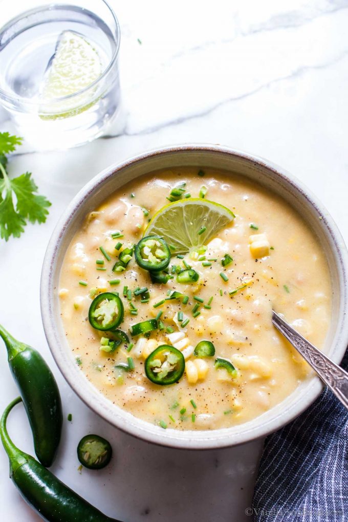 Veggie Corn Chowder Recipe in a bowl garnished with jalapenos, cilantro and lime.