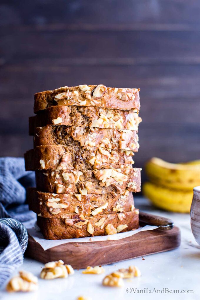 Banana Bread Recipe with Brown Sugar stacked tall on a cutting board.