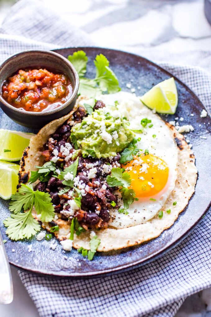 Huevos rancheros with a fried egg and beans on a plate.