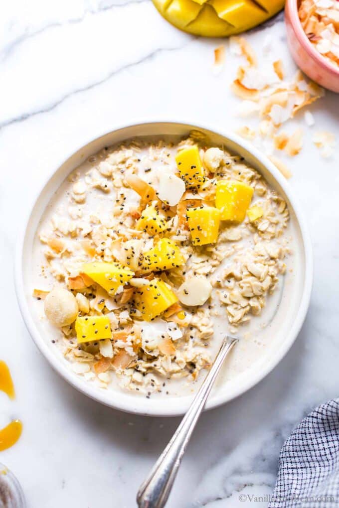 Overnight Oats with coconut milk topped with mango and chia seeds.
