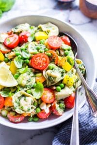 Cheese tortellini with pesto pasta salad in a bowl ready to share.