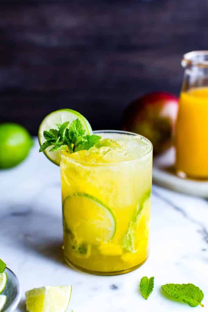 Mango Mojito Recipe in a glass garnished with mint and lime. 