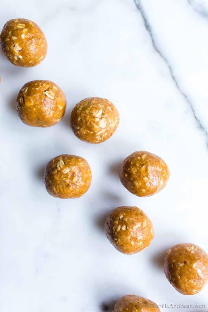 3 Ingredient peanut butter oatmeal balls on a marble table.