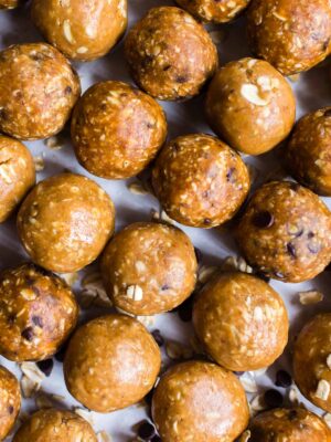 Close up of 3 ingredient peanut butter balls lined up on a sheet pan.