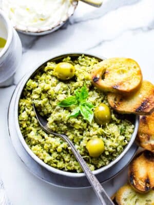 Green Olive Tapenade Recipe in a bowl with crostini.