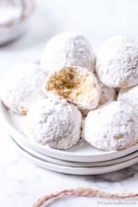 Close up image of Italian Wedding Cookies Recipe with a bite out of a cookie.