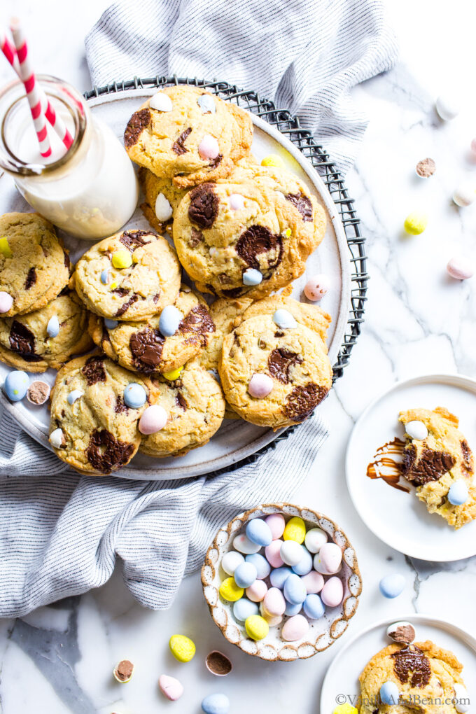 Chocolate Chip Mini Egg Easter Cookies on a platter with a jar of milk.