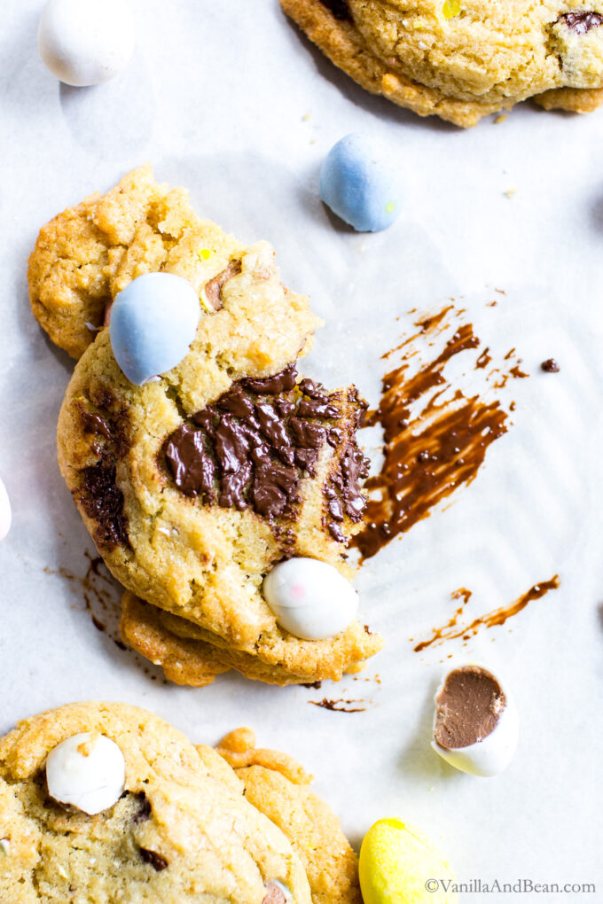 Half a Mini Egg Cookie on a sheet pan with a schmear of melted chocolate.