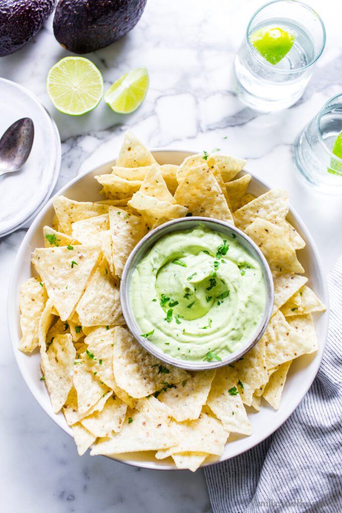 Avocado lime crema in a bowl with tortilla chips