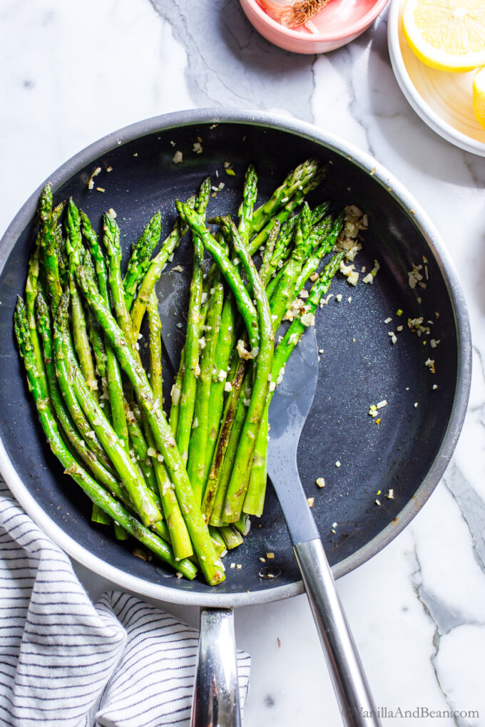 Asparagus in a pan just pan fried with garlic and shallots.
