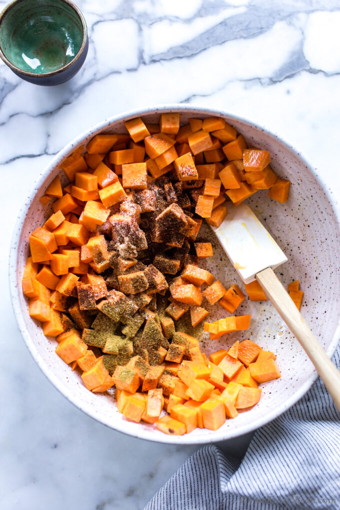Seasoned sweet potatoes and black beans in a bowl.