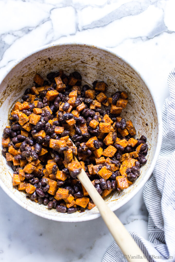 Seasoned sweet potatoes and black beans in a bowl.