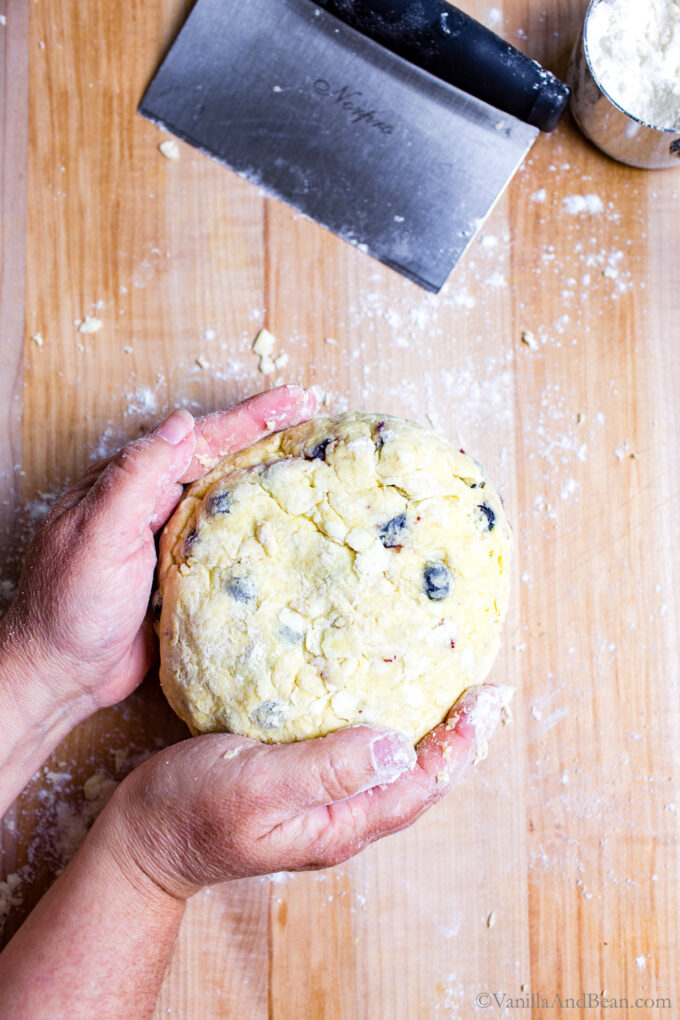 Shaping sourdough scone dough on a board.