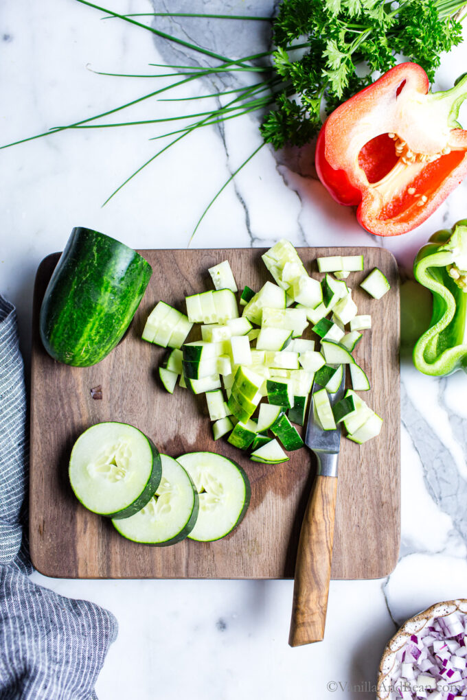 Chopped cucumbers on a cutting board.