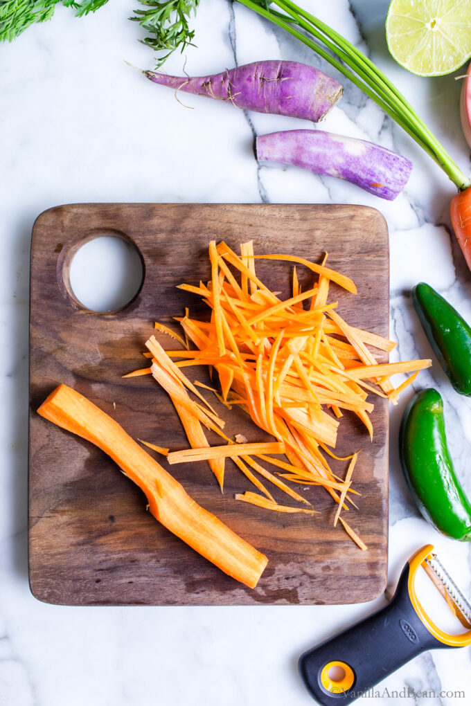 Shredded carrot on a cutting board.