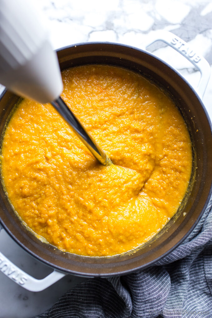 Sweet Potato Carrot Ginger Soup being purred in a Dutch oven.