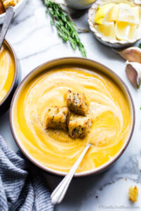 Vegetarian or Vegan Sweet Potato and Carrot Soup in a bowl garnished with croutons.