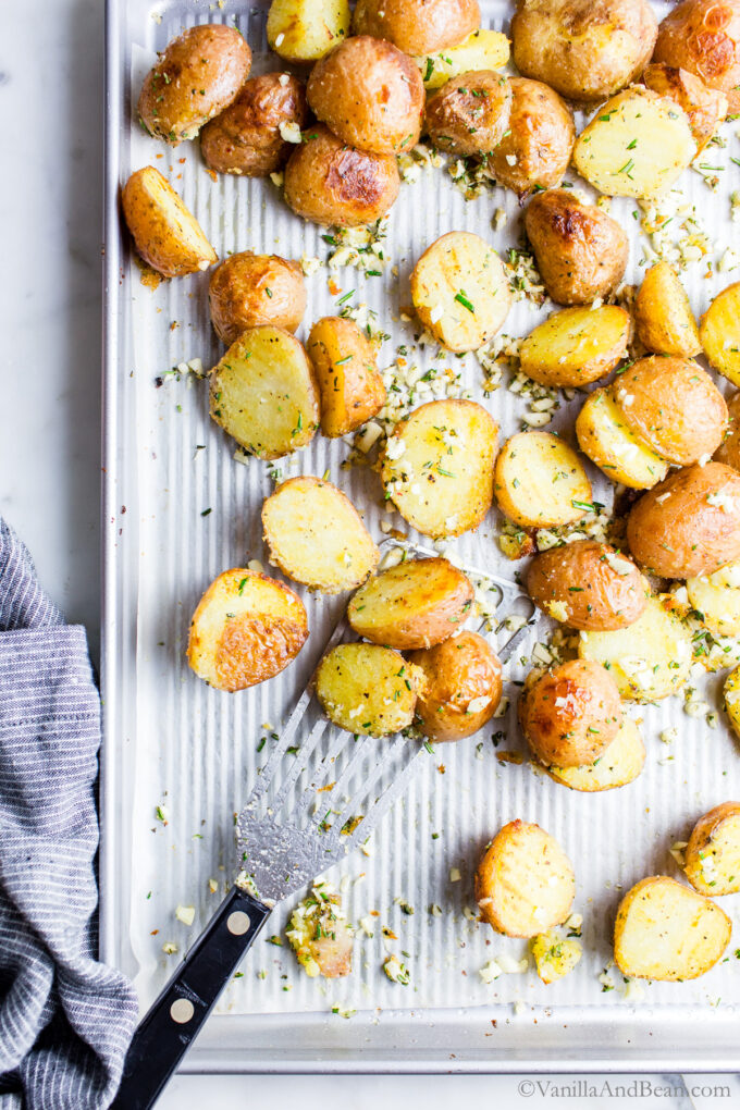 ParBoiled and roasted potatoes on a sheet pan with olive oil, rosemary and garlic.
