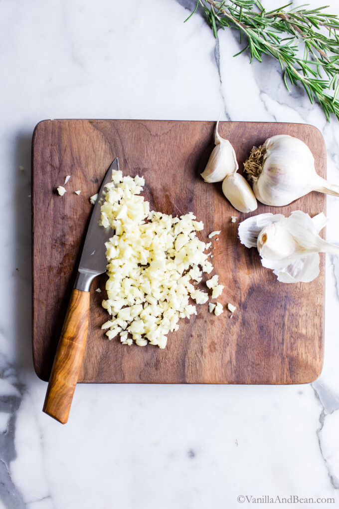 Minced garlic on a cutting board.