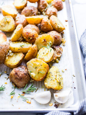 Close up of Roasted Garlic Rosemary Potatoes on a sheet pan.