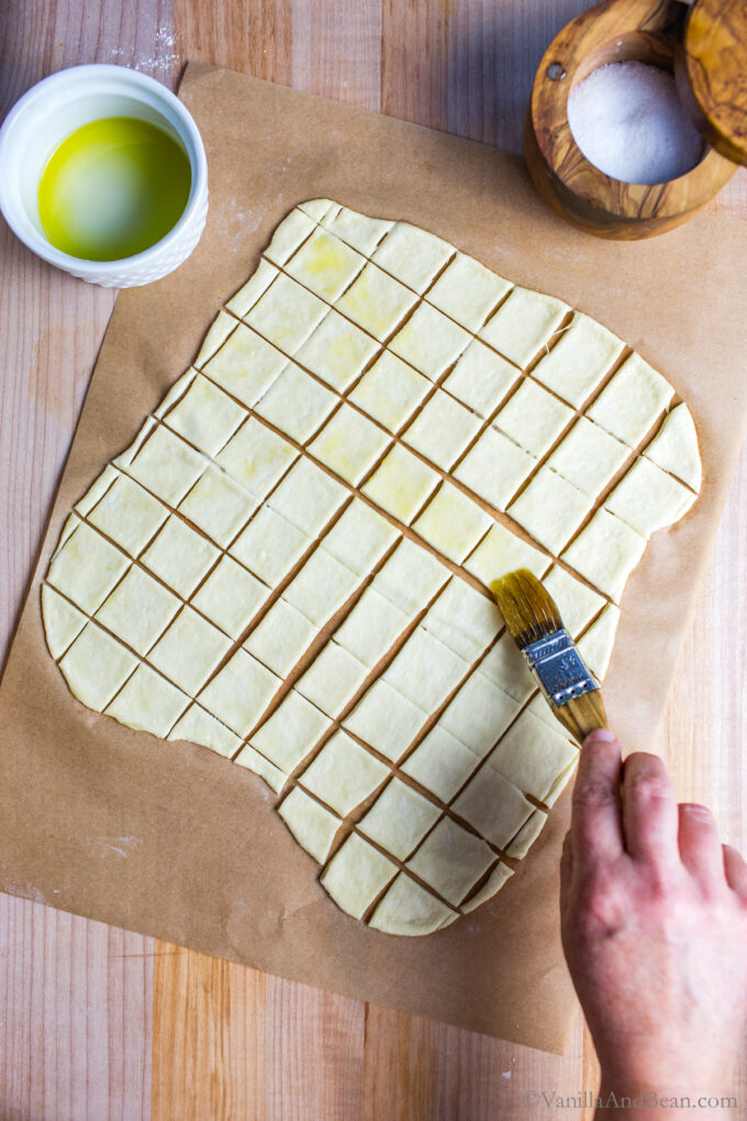 Brushing Olive Oil on Sourdough Discard Crackers.