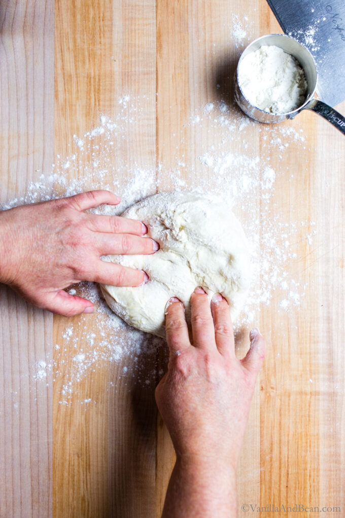 Dimple the pizza dough.