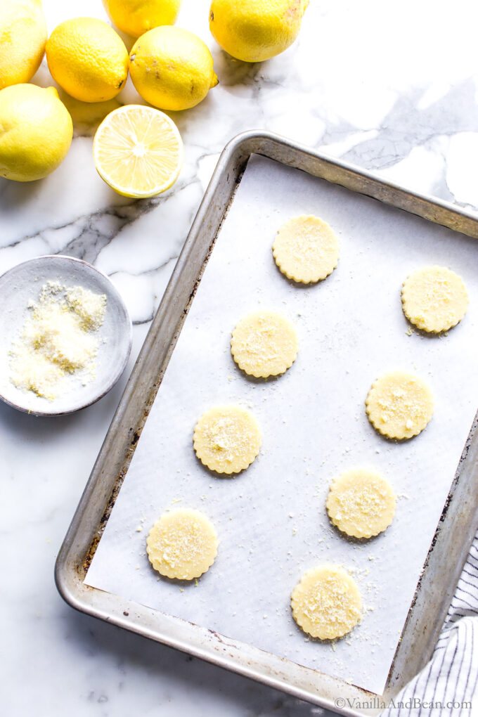 Lemon cutout cookie dough on a sheet pan.