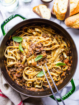 Vegetarian mushroom bolognese in a Dutch oven garnished with basil.