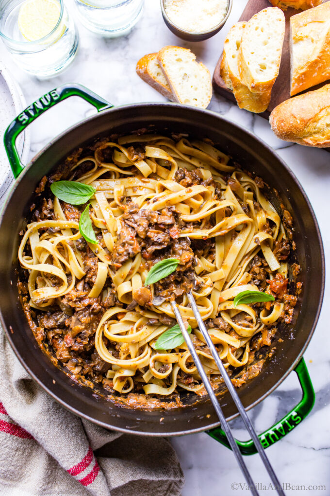 Vegetarian mushroom bolognese in a Dutch oven garnished with basil.