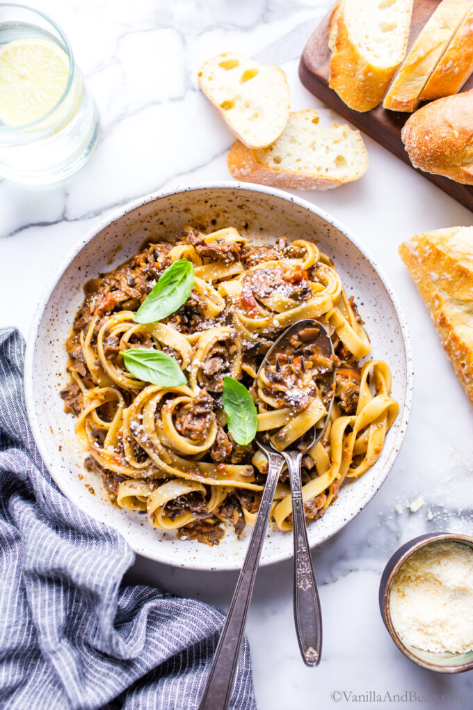 Vegetarian mushroom bolognese sauce in a bowl garnished with basil.