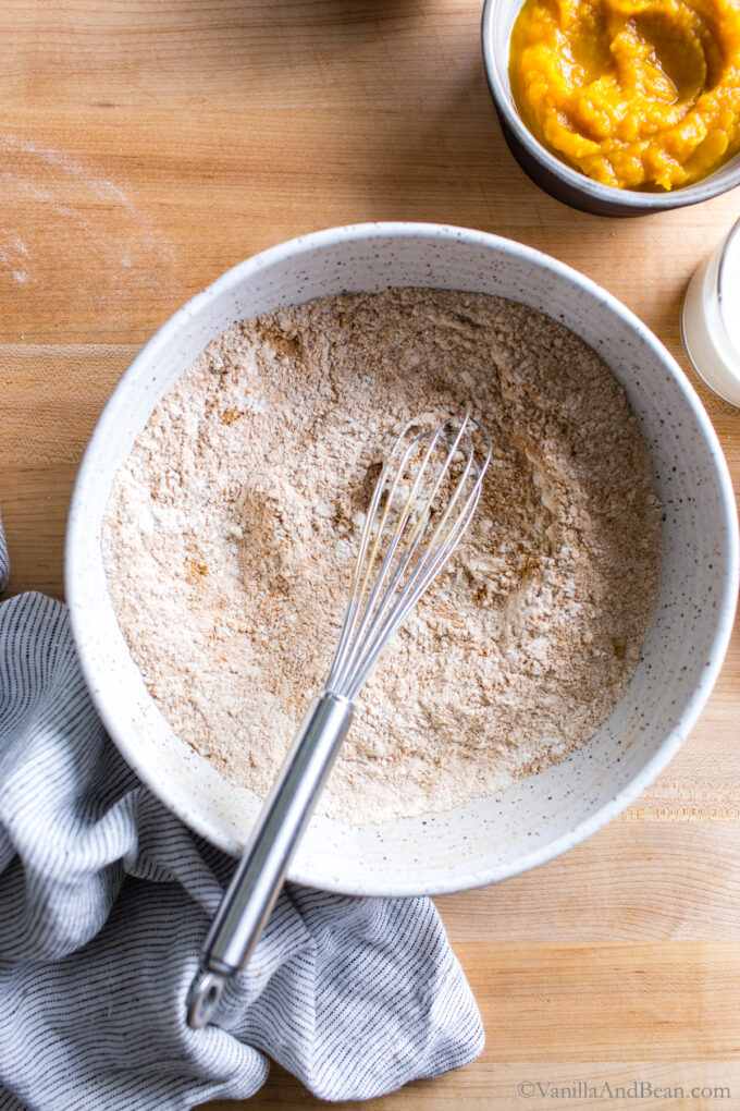 Whisking dry ingredients in a bowl.