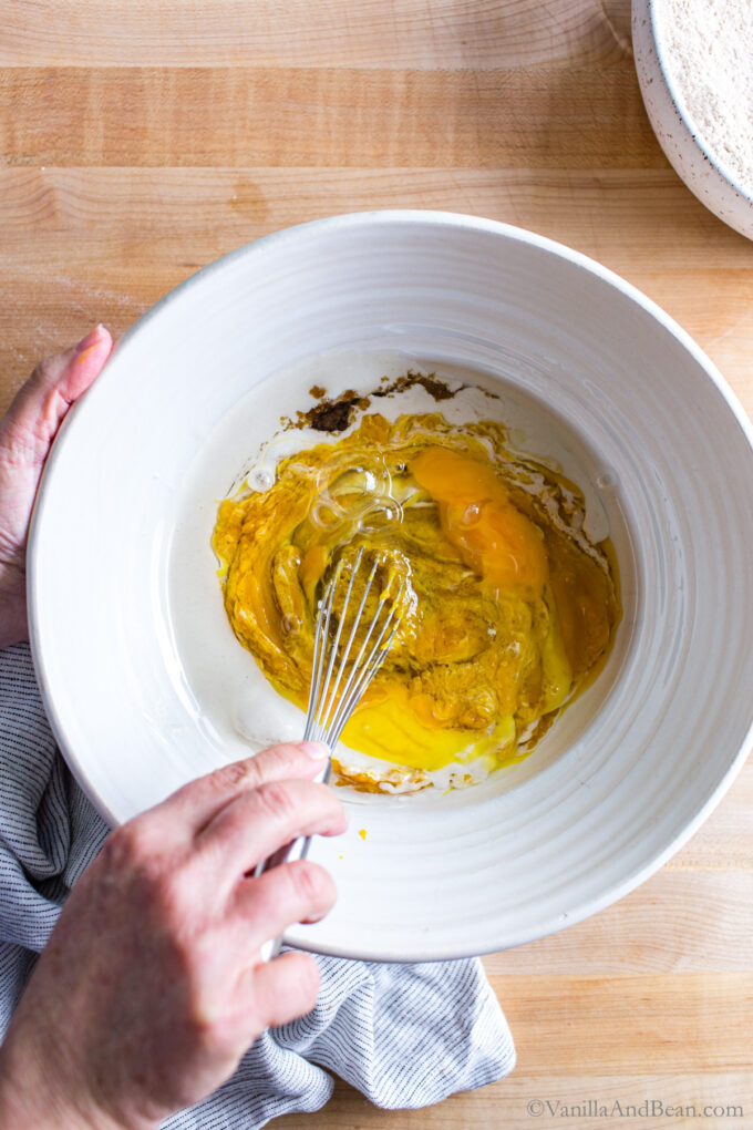 Whisking wet ingredients in a bowl.