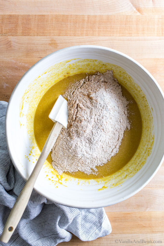 Mixing sourdough discard pumpkin muffins batter in a bowl.