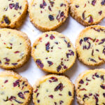baked cranberry orange cookies on a sheet pan. .