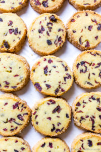 baked cranberry orange cookies on a sheet pan. .