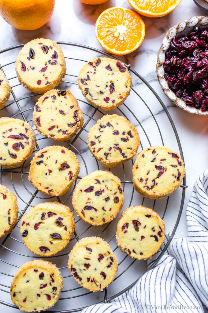 Baked cranberry orange cookies on a cooling rack.