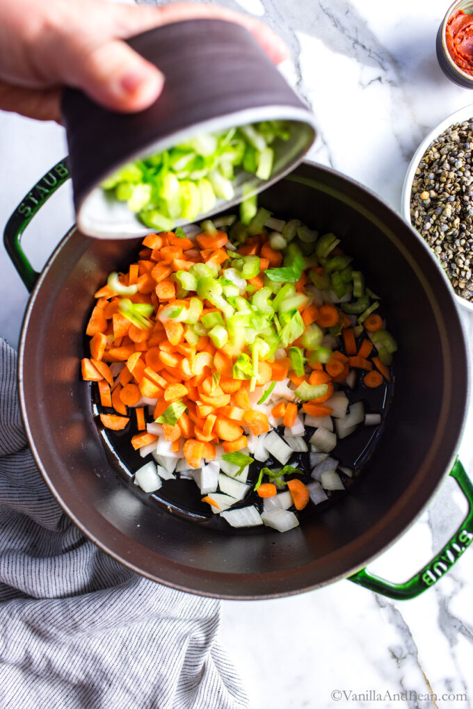 In a dutch oven, are onions, carrots and celery.