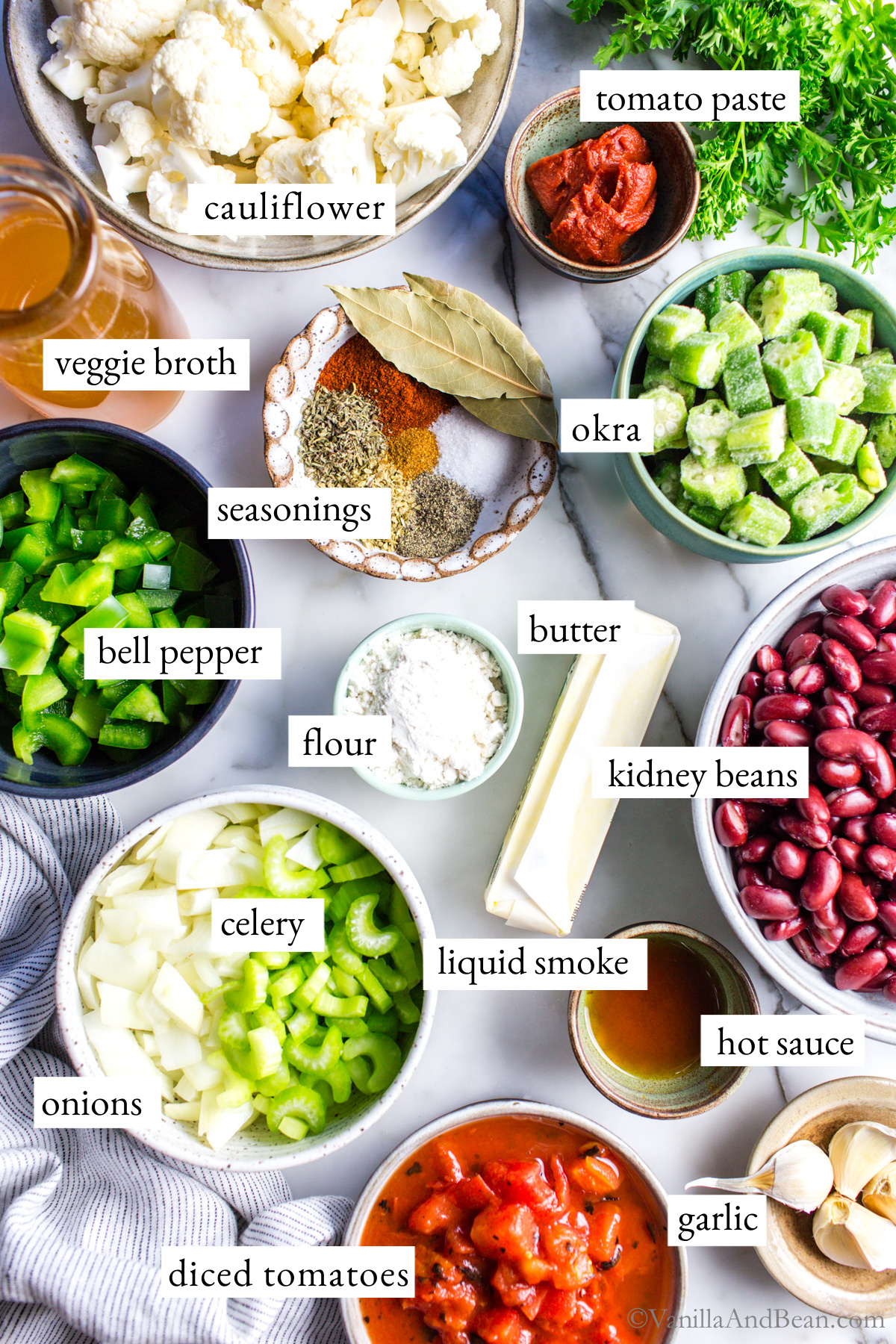 Ingredients for a vegetable gumbo recipe on a table.