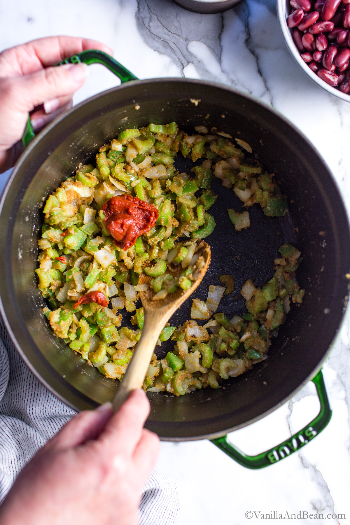 Once the veggies are stirred, coated and cooked in the roux, tomato paste is added.