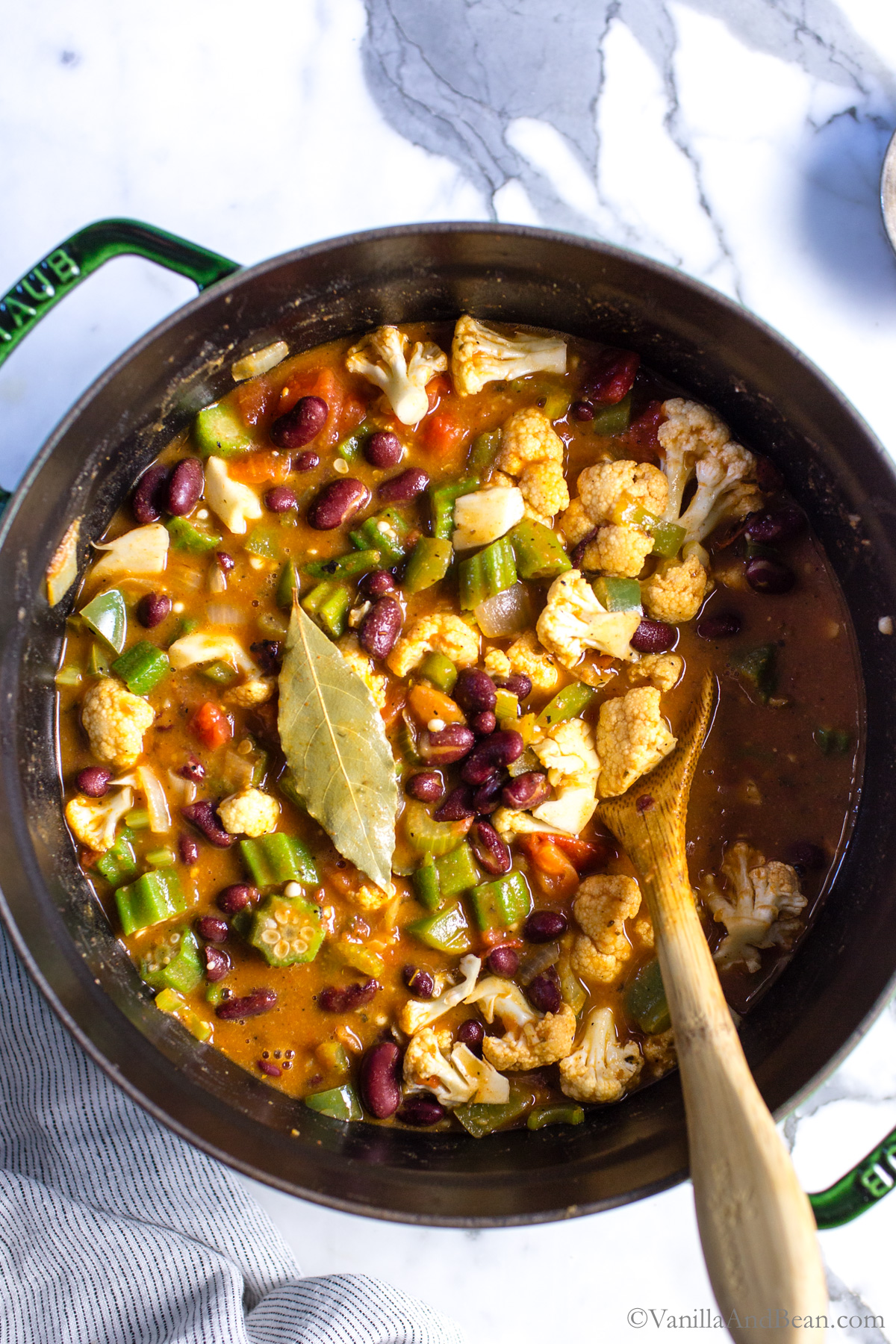 Ingredients are stirred in the Dutch oven, and the vegetable gumbo is ready to finish cooking.