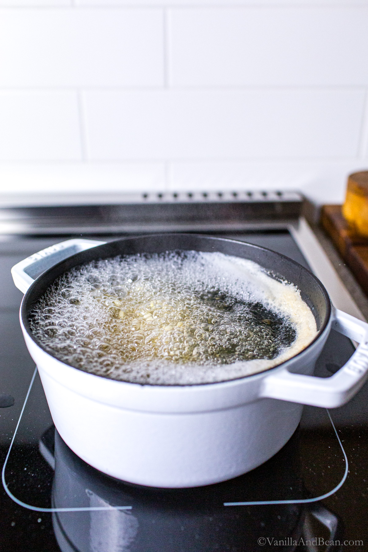 Dutch oven with rice and boiling water on the stove top.