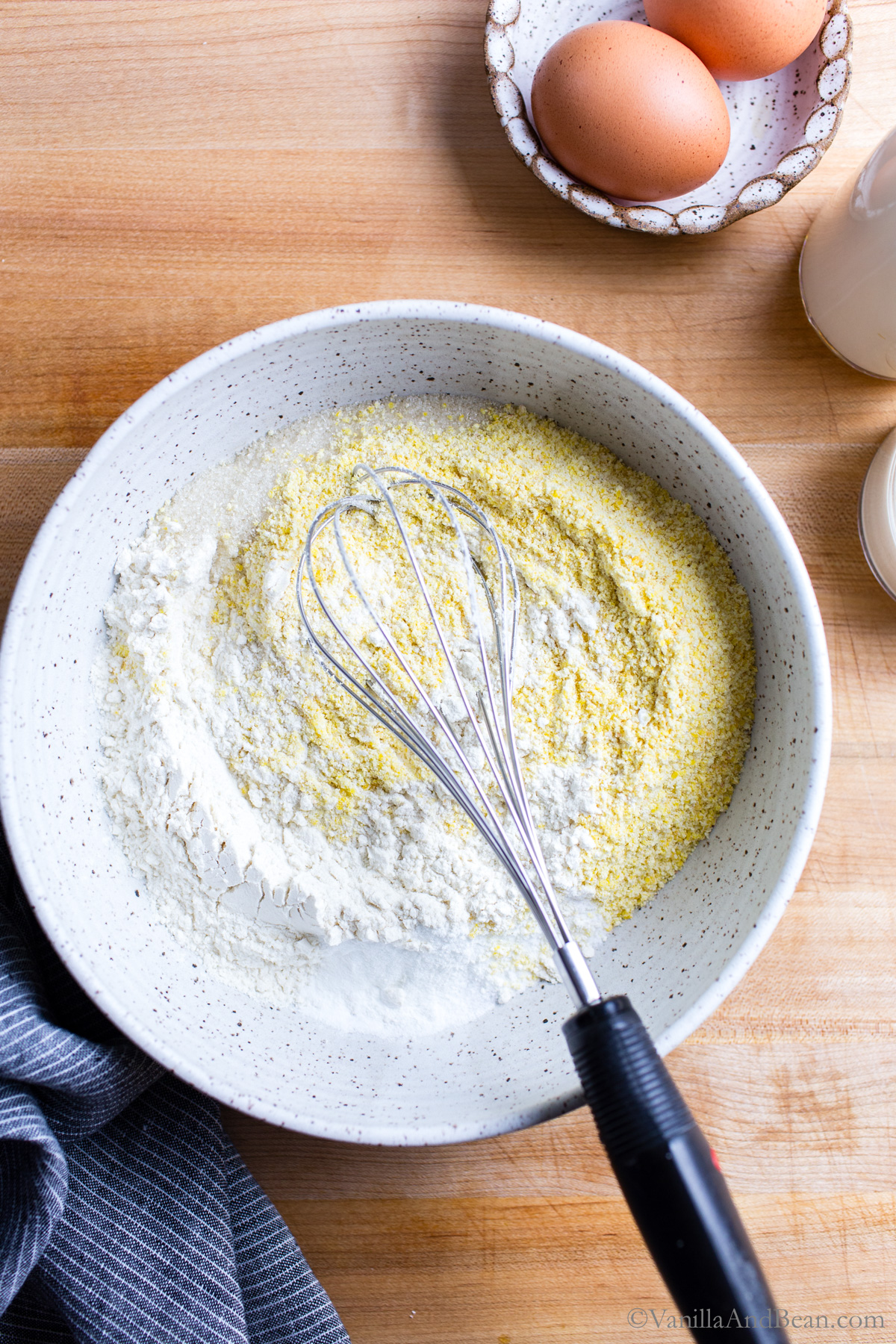 Sourdough cornbread dry ingredients in a bowl with a whisk.