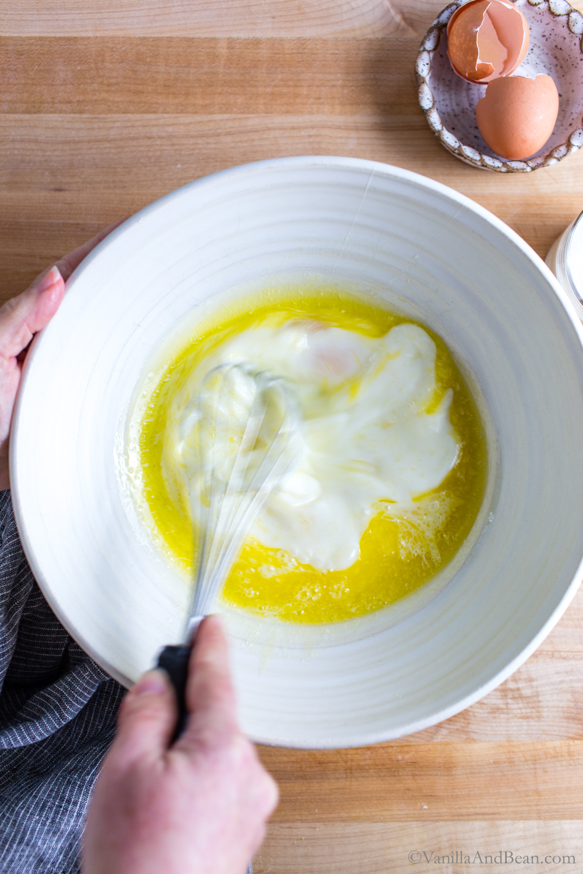Whisking eggs into the butter/milk mixture.