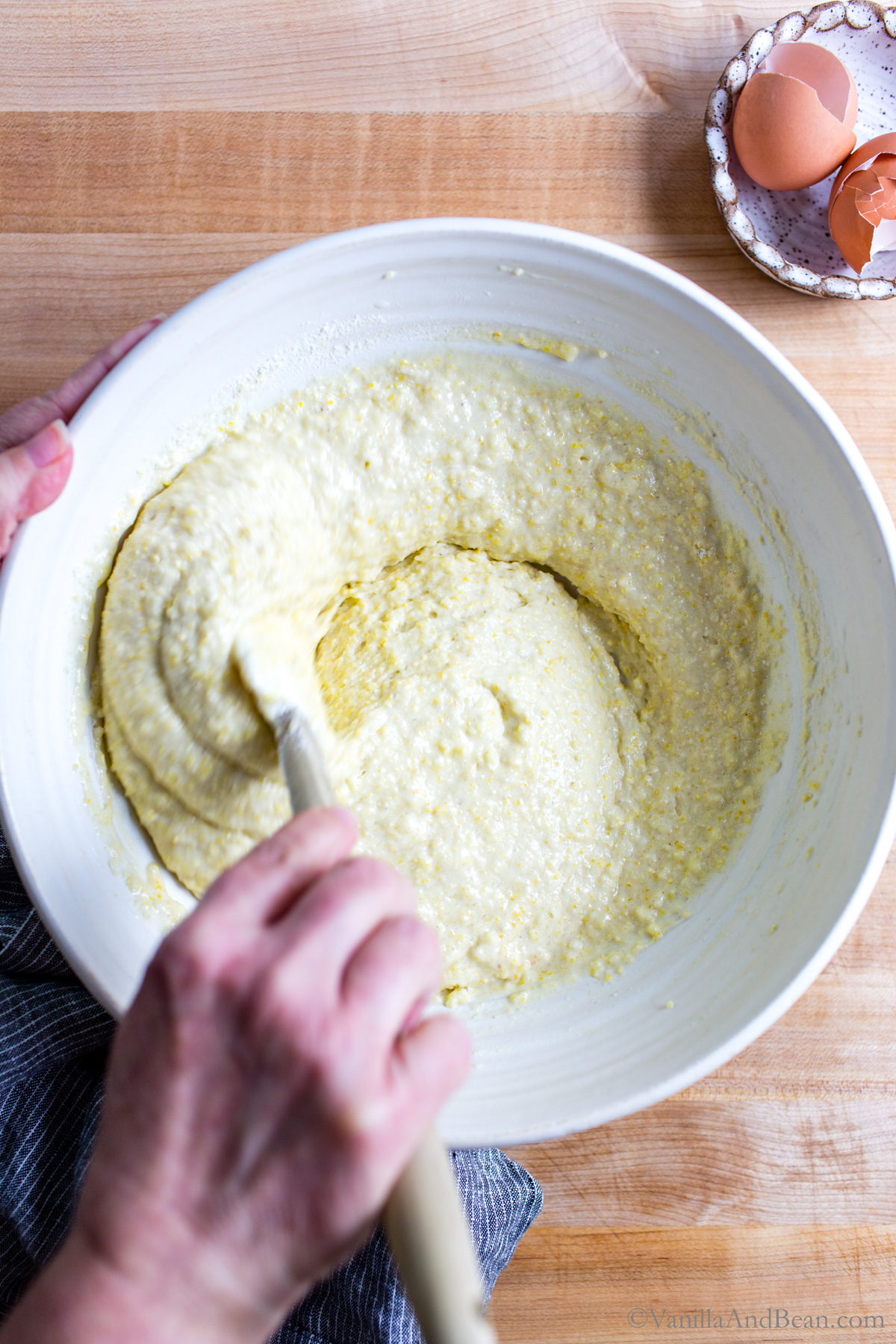 Mixing the sourdough cornbread batter in a bowl.